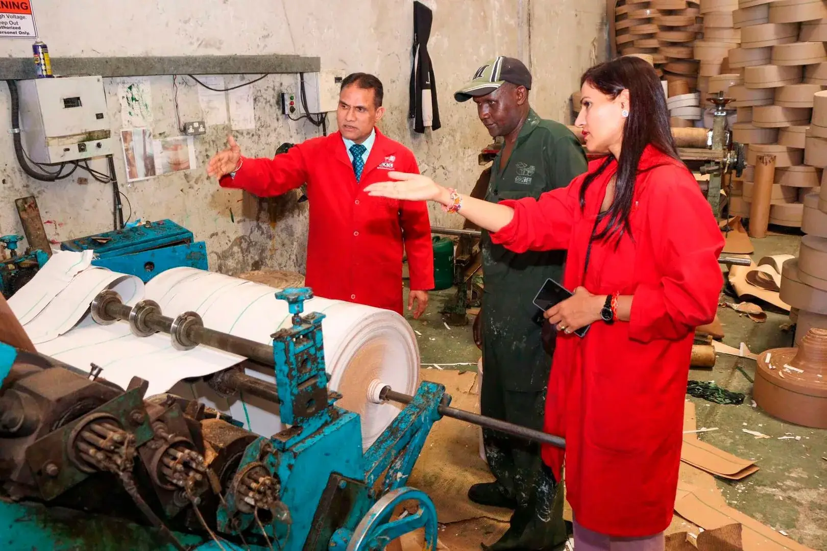 SKL Managing Director Sonvir Singh and Finance Director Nirmal Chaudhary interact with an employee at the SKL production facility in Nairobi